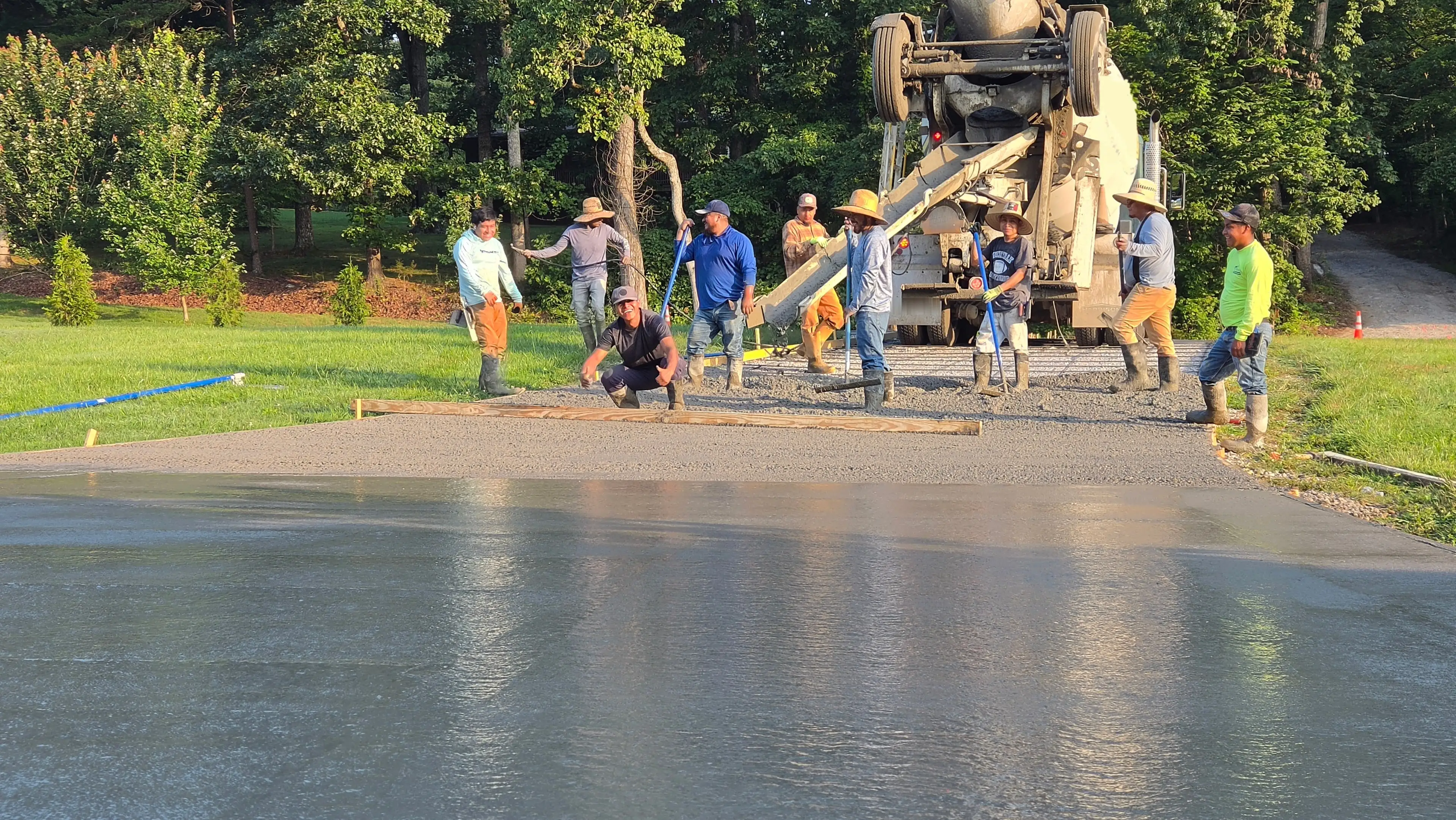 Constructive Landscaping crew pouring concrete driveway
