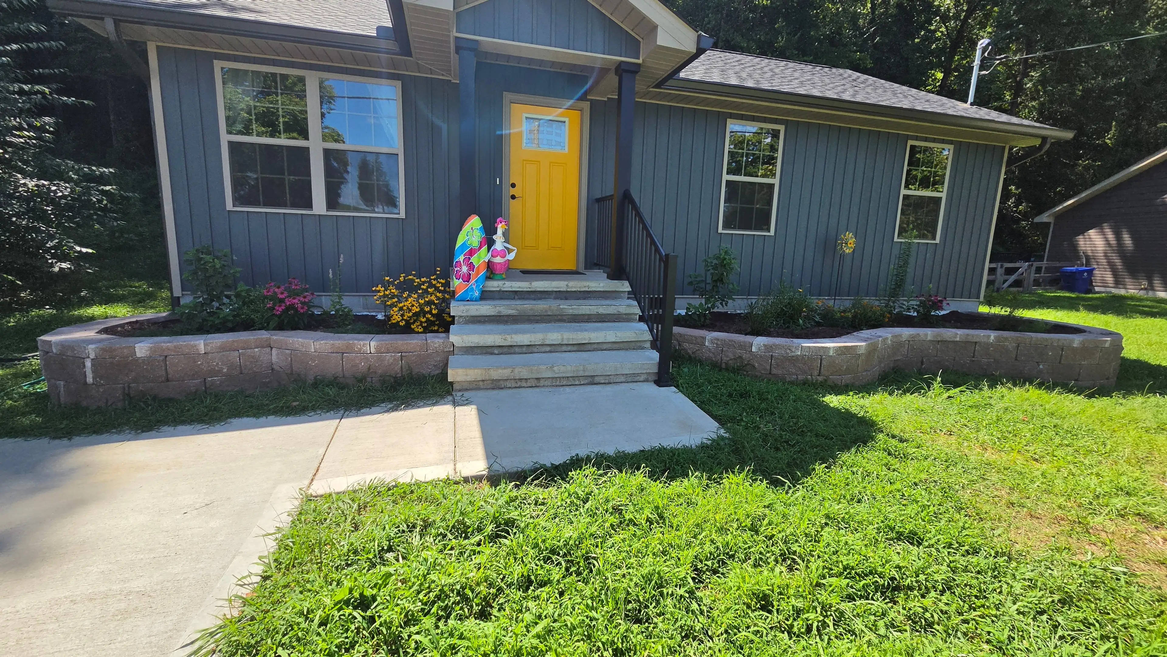 Front yard retaining walls with natural stone steps and landscaping