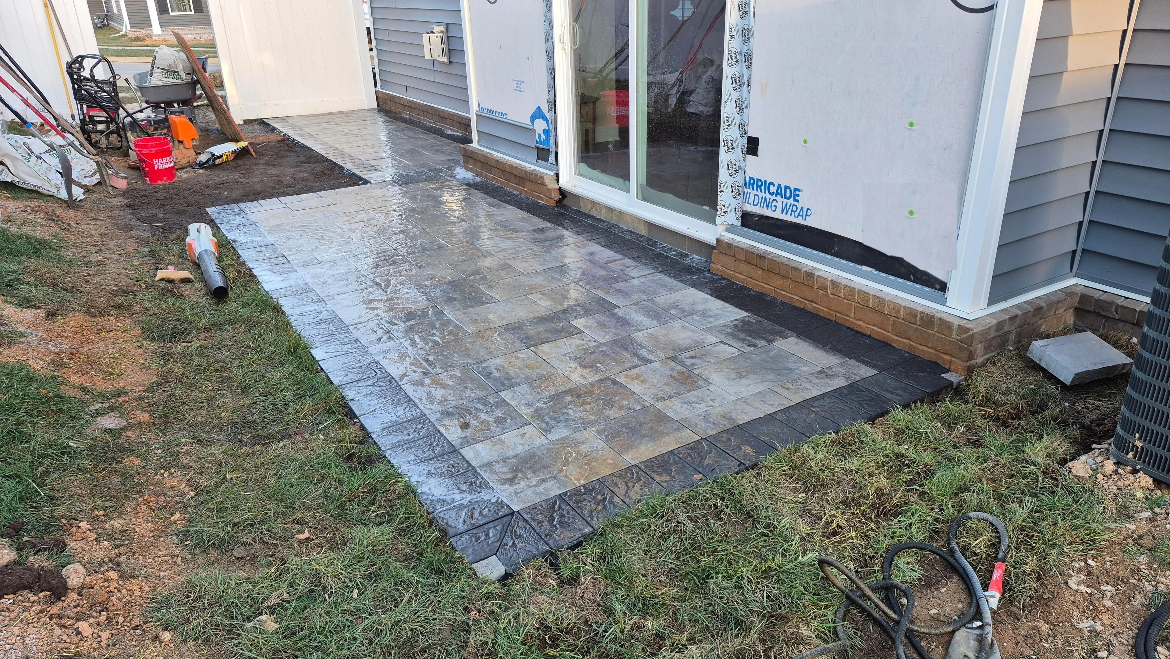 Freshly laid paver patio on new construction home