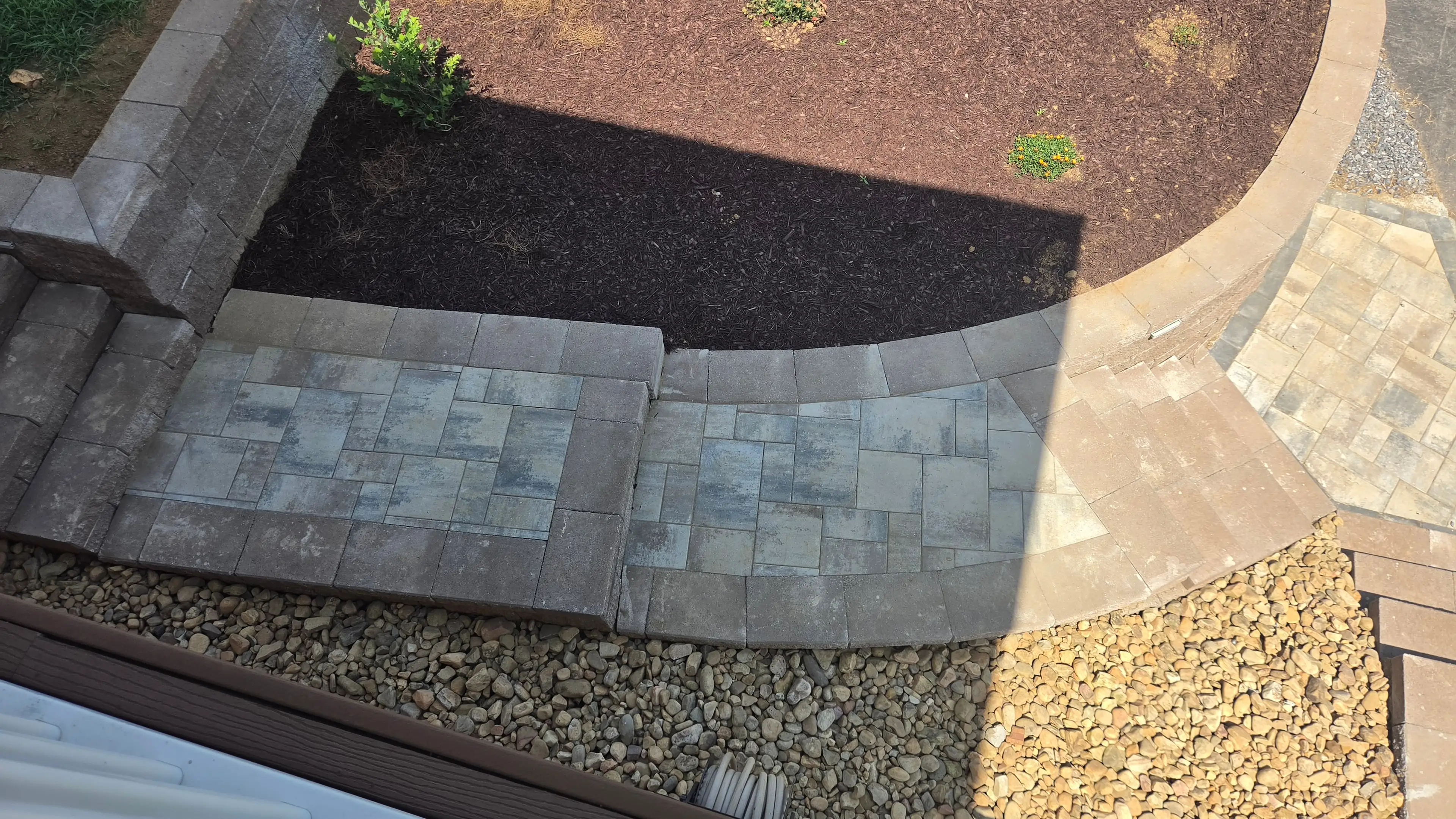 Aerial view of paver steps, retaining wall, and mulch beds